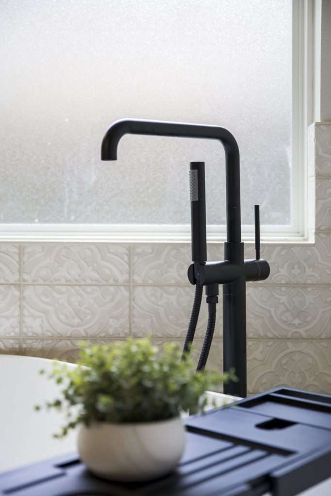 A bathroom sink with a plant decoration