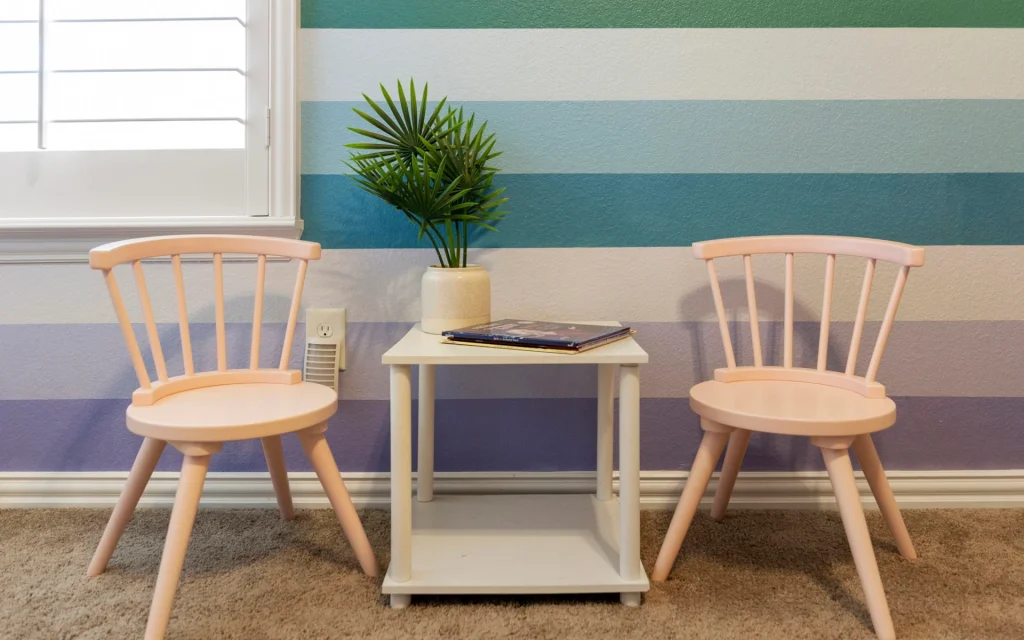 Two chairs and a table in a kid's room