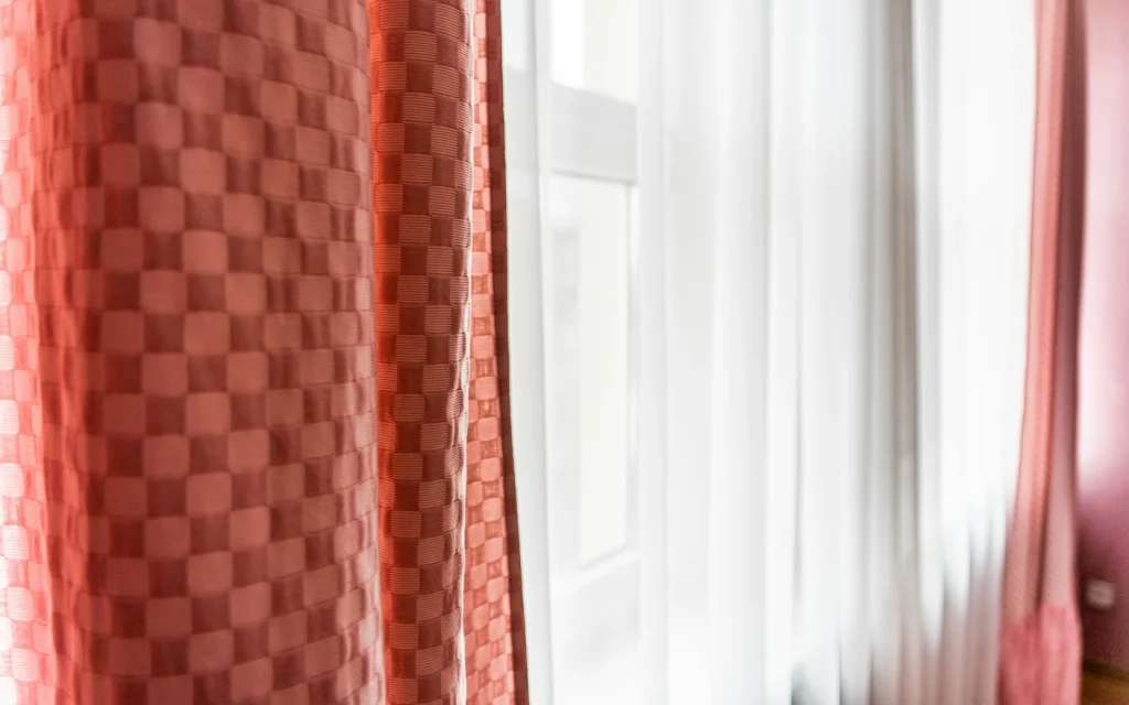 Red curtains paired with a white one
