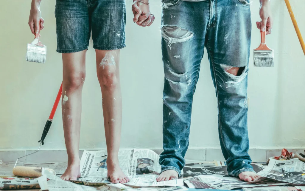 Two people painting the house