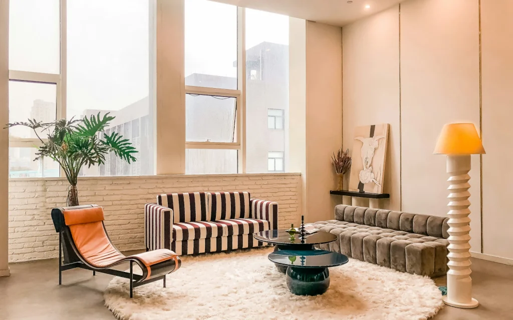 A room with a high ceiling and stripped armchairs