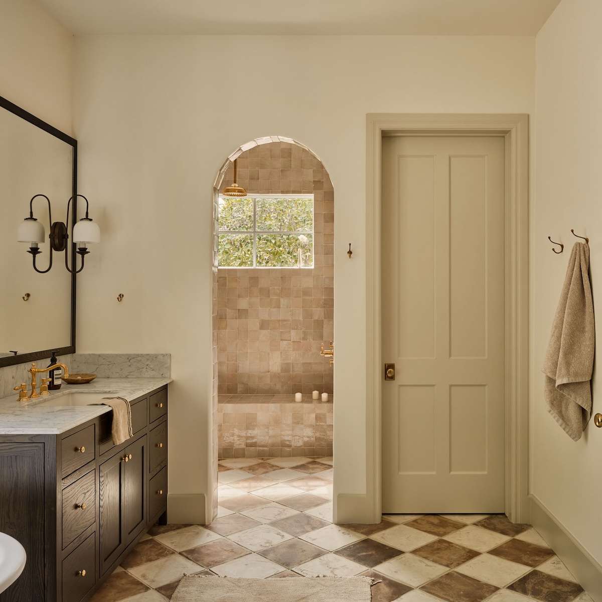 Gold fixtures paired with mosaic tiles  bathroom design