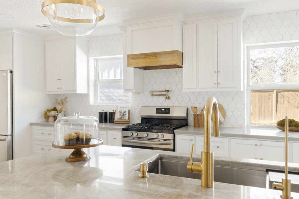 modern kitchen with white cabinets and golden facets