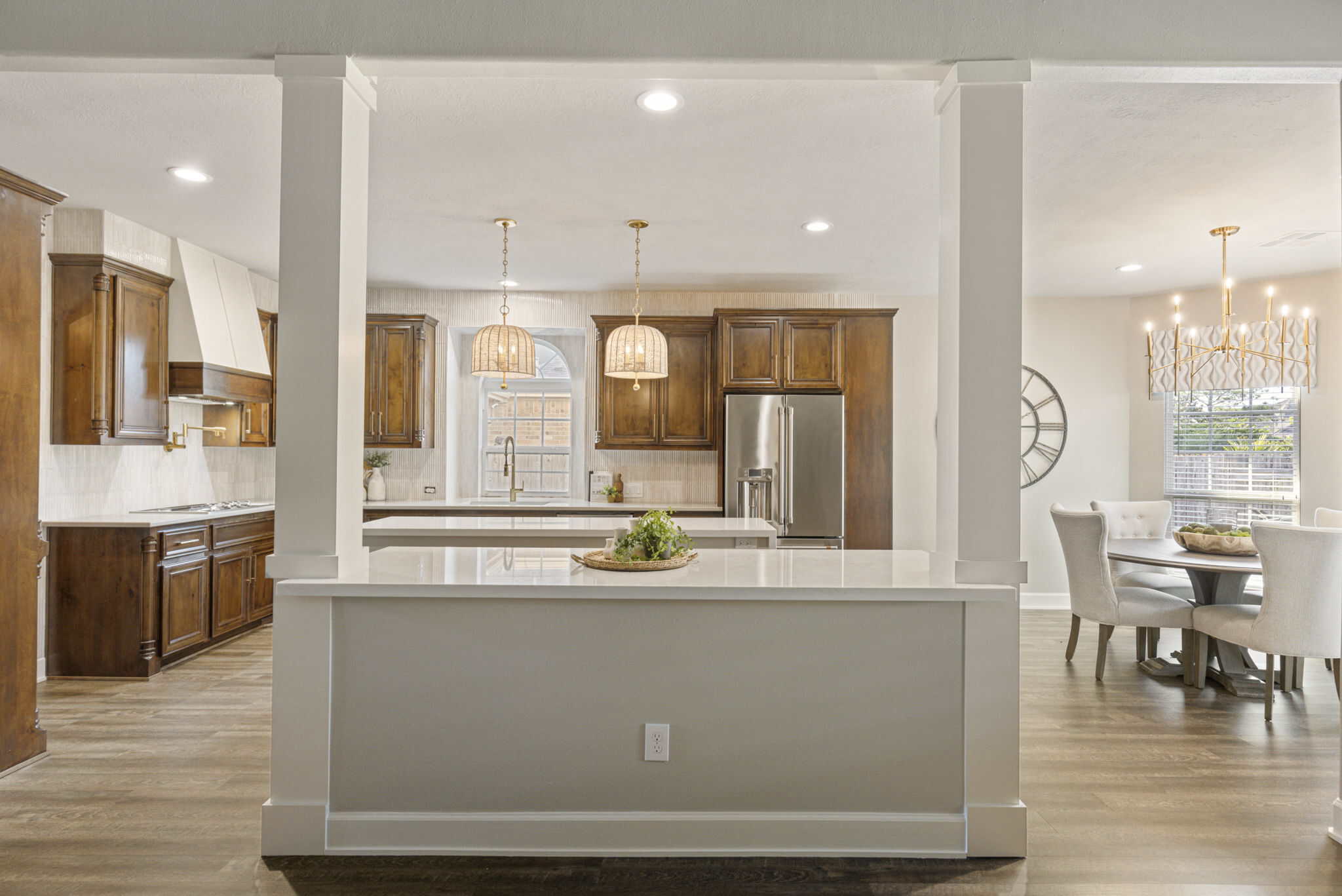 Elegant open-concept kitchen and dining room interior pacious kitchen and dining area with wooden cabinets and modern pendant lights