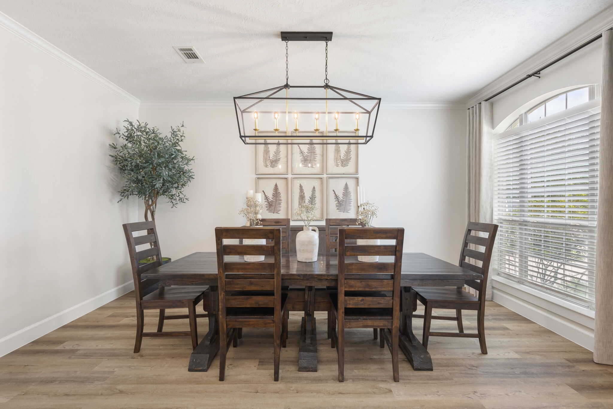 Bright dining area with natural light and wooden furniture Elegant dining room with wooden table, chairs, and large window