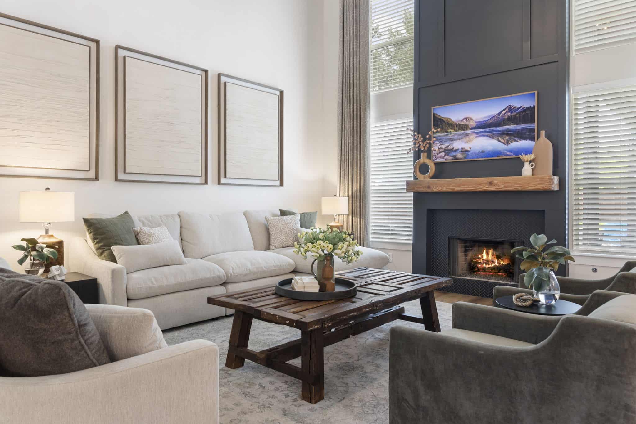 Contemporary living room design with cozy fireplace and natural light Modern living room with neutral tones, tall windows, and a dark accent fireplace wall