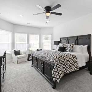 After Renovation – Modern Bedroom with Dark Wood Furniture Elegant bedroom after renovation with dark wood bed, neutral bedding, bedside tables, and bright natural light from multiple windows