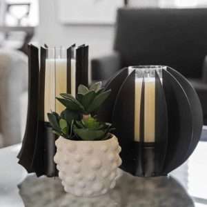 After Renovation – Modern Coffee Table Decor with Candles and Succulent Close-up of coffee table decor featuring black candle holders and a small succulent plant in a textured white pot