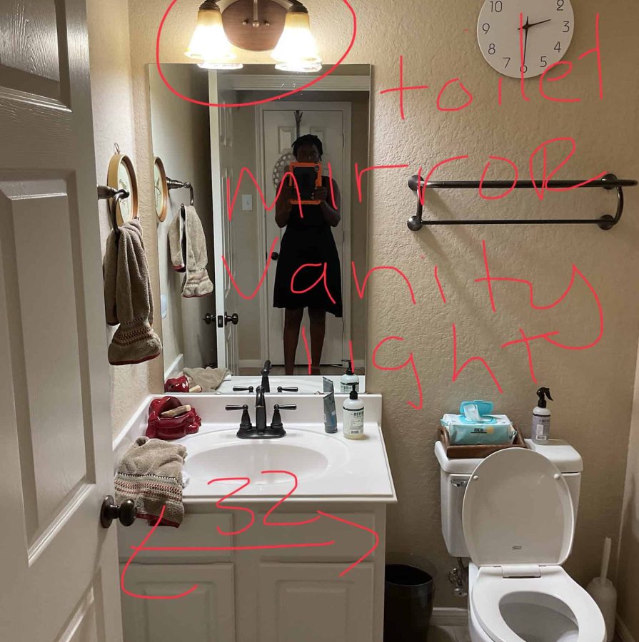 Small bathroom before renovation with a white vanity, mirror, wall light fixture, beige walls, and toilet on the right side
