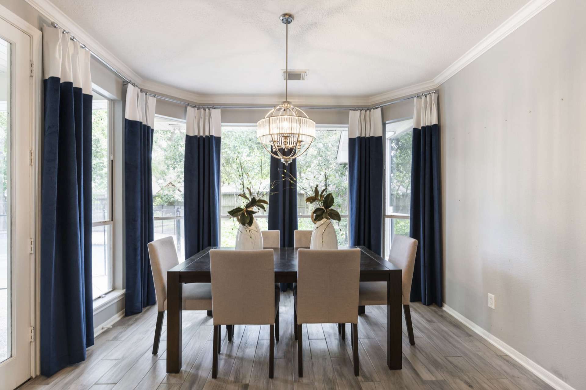 Custom navy velvet drapery and window treatments in a Houston-area dining nook