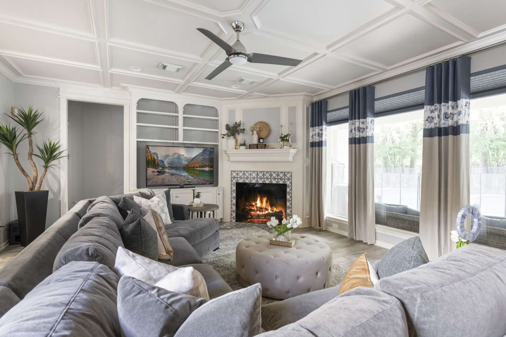 Interior design living room with coffered ceiling and layered drapery in Greater Houston